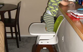 baby-boy-standing-high-chair