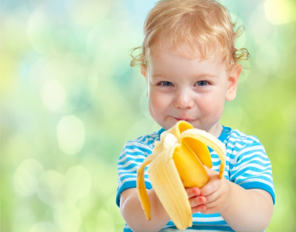 happy kid eating banana fruit